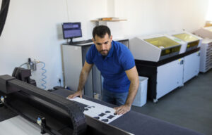 Hispanic mature man working in printing office